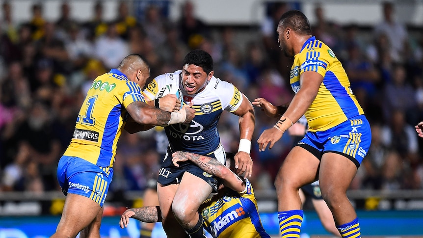Jason Taumalolo of the Cowboys is tackled by Manu Ma'u of the Eels during the round 20 NRL match