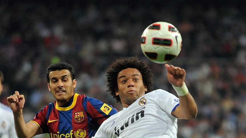All square ... Marcelo looks to clear the ball as Pedro Rodriguez looks on.