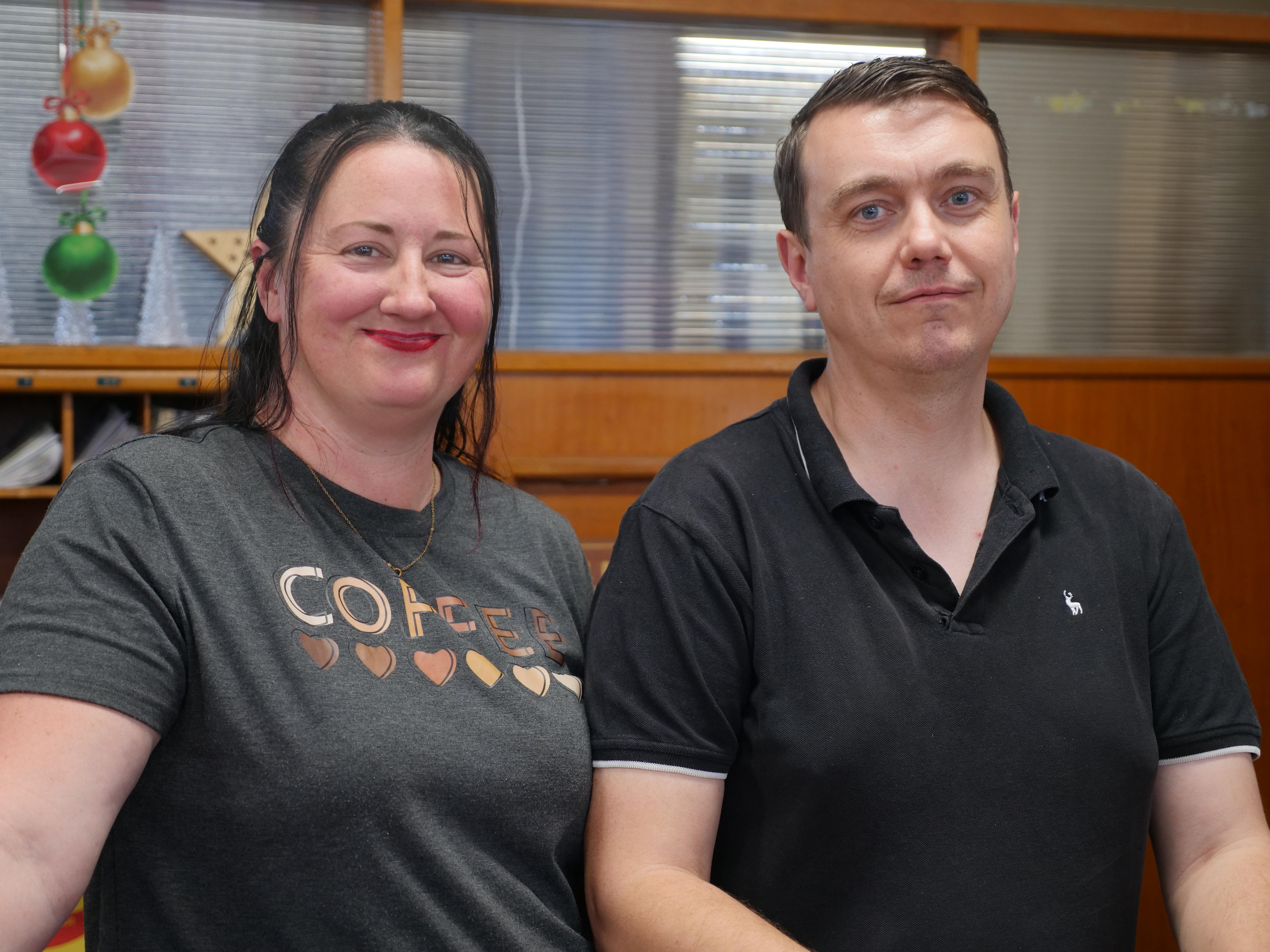 Middle aged couple, man and woman smiling at the camera.