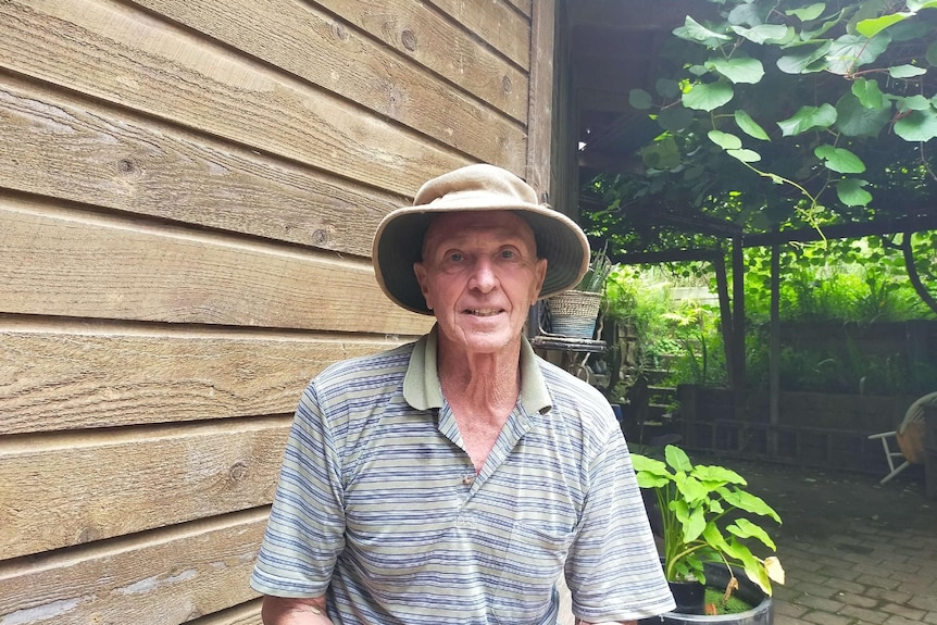 Jeff Aschmann wearing a wide brim hat sitting outside.