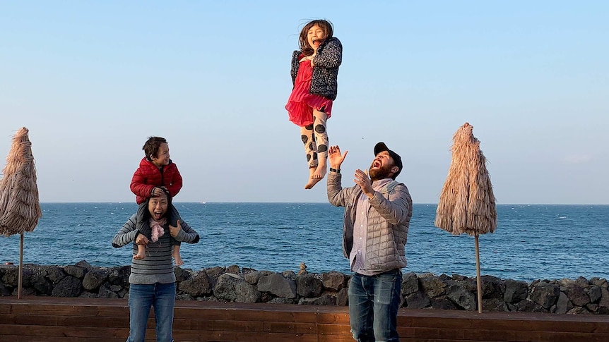 Family shot of David Stuart with wife Junko and kids Juna and Remy enjoying the beachside in Jeju, South Korea.