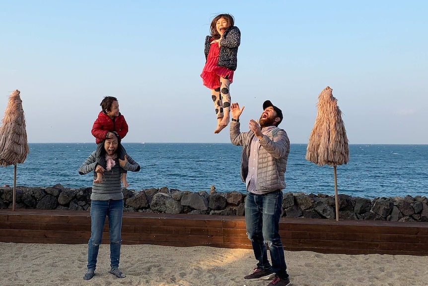 Family shot of David Stuart with wife Junko and kids Juna and Remy enjoying the beachside in Jeju, South Korea.