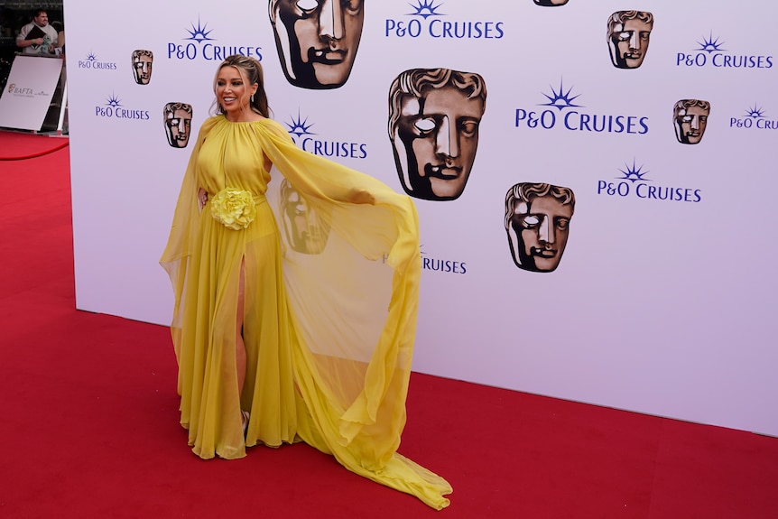 Dannii Minogue in a yellow gown.