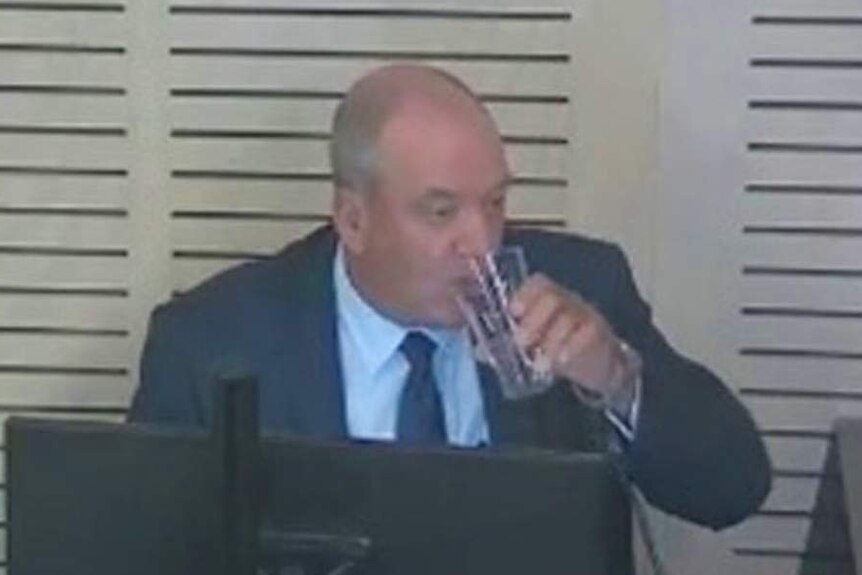 A man drinks a glass of water