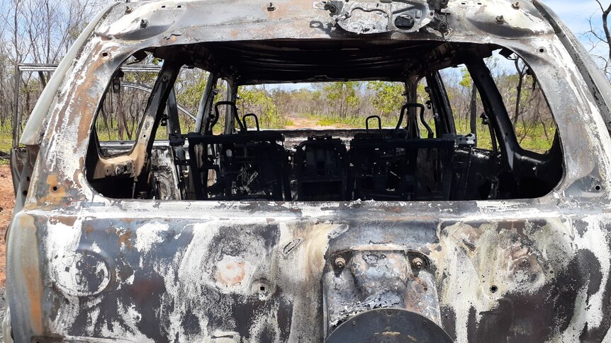 Image of a thoroughly burned-out shell of a stolen car