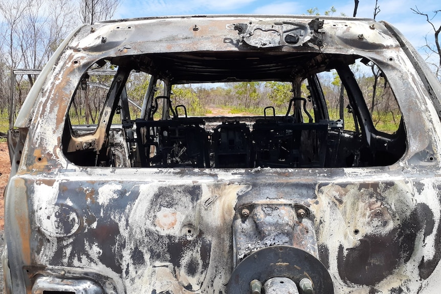 Image of a thoroughly burned-out shell of a stolen car