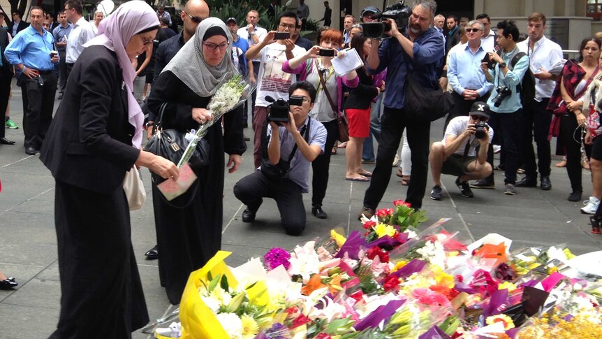 Two Muslim women lay flowers at a memorial in Sydney's Martin Place for the victims of the Lindt Cafe siege in December 2014.