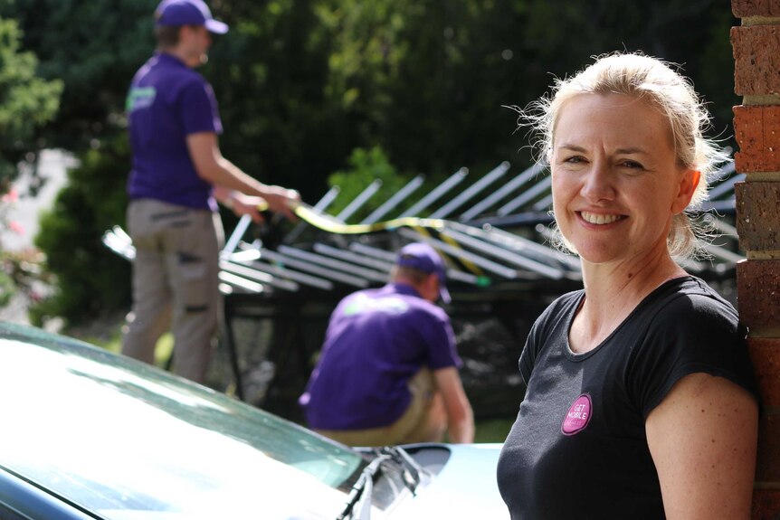 Tasmanian Leah Horman, with her trampoline being assembled by professional assemblers in Hobart.