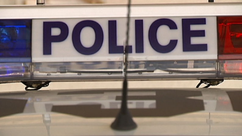 Sign and lights on top of SA police car.