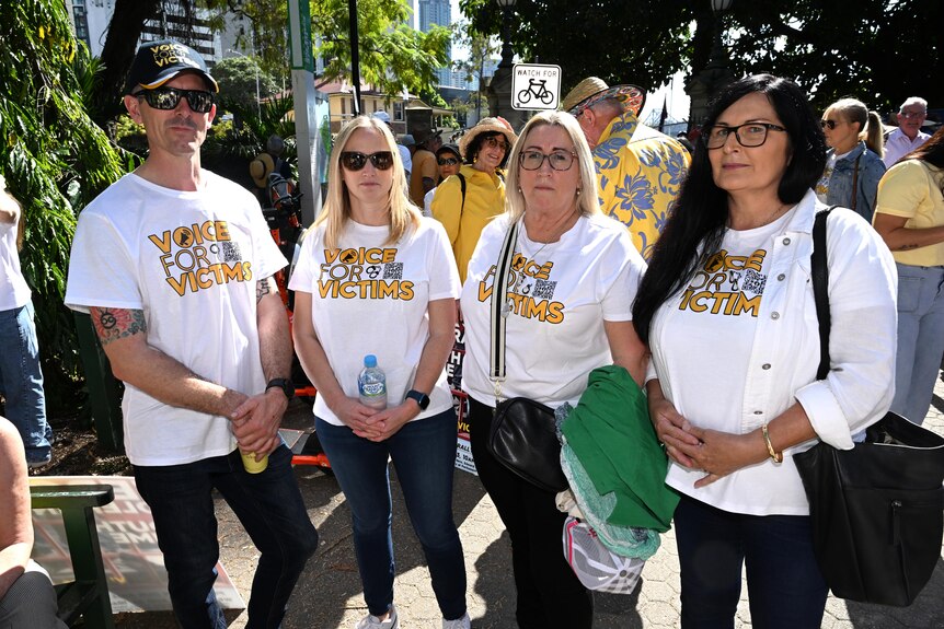 Lee Lovell wears a 'Voice for Victims' shirt with other victims
