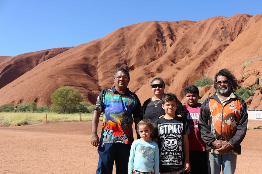 Darrell Graham and his family stand in front of Uluru