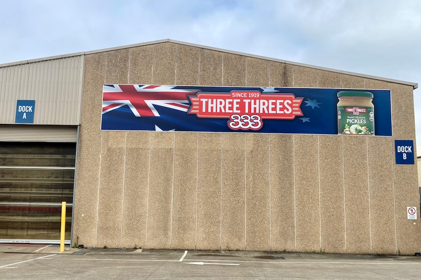 The exterior of a factory with Three Threes logo and Australian flag brand.