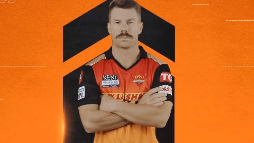 David Warner folds his arms and looks serious in his Sunrisers Hyderabad kit.