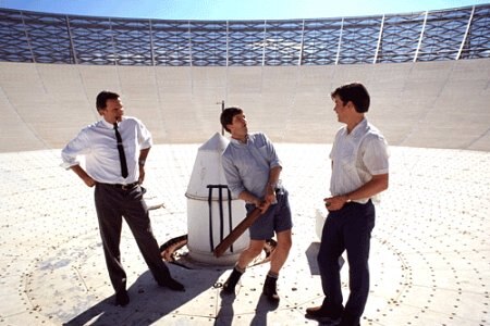 Three people playing cricket on the dish