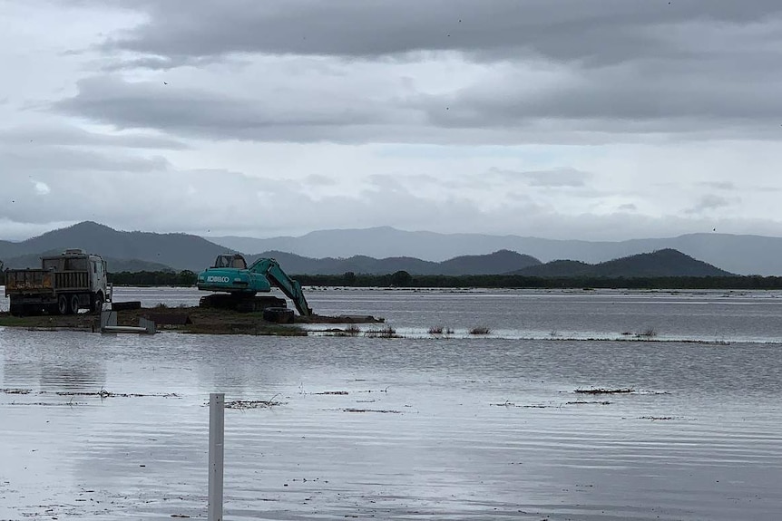 Excavators trapped by flood waters at a cane farm