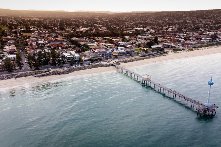 An overhead drone shot of Adelaide's Brighton beach and jetty.