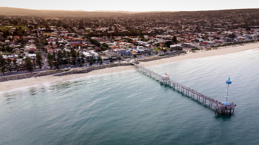 An overhead drone shot of Adelaide's Brighton beach and jetty.