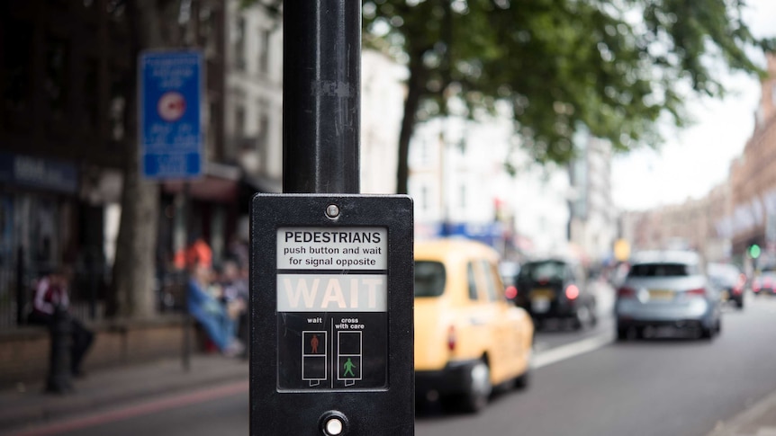 Pedestrian crossing button on a street