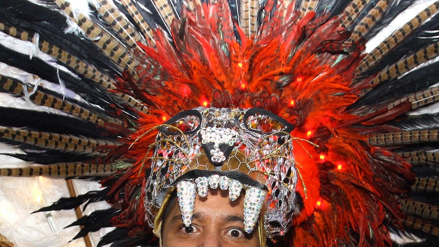 Mardi Gras reveller wears feathery headdress