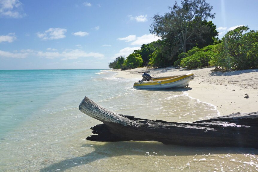 Boat on beach of Capricornia Cays National Park on North West Island off central Queensland.
