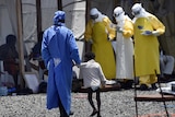 Nurse walks with young Ebola victim