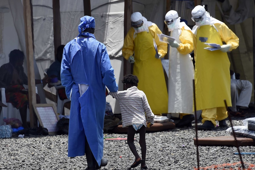 Nurse walks with young Ebola victim