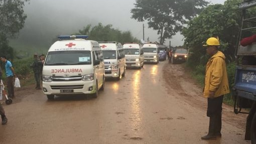 A row of ambulances heads into the cave site amid reports the rescue is underway or imminent.