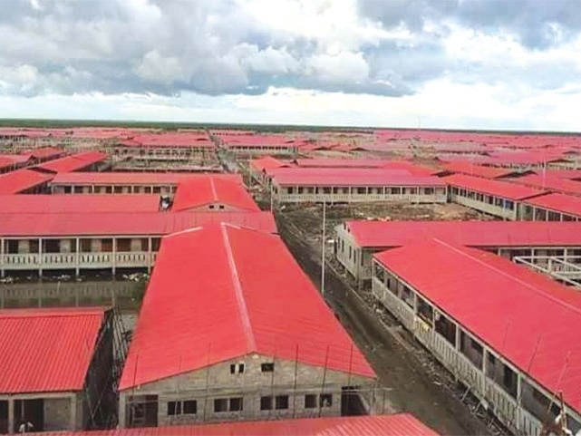 An aerial view of the roofs of houses in a sprawling grid