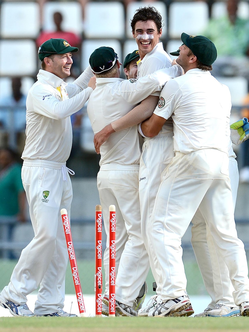 Mitchell Starc is congratulated by team-mates.