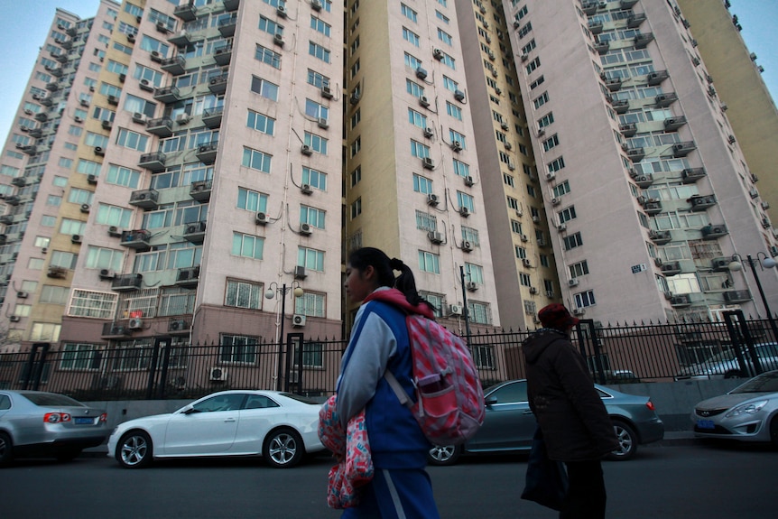 a girl walk through apartment buildings in Beijing