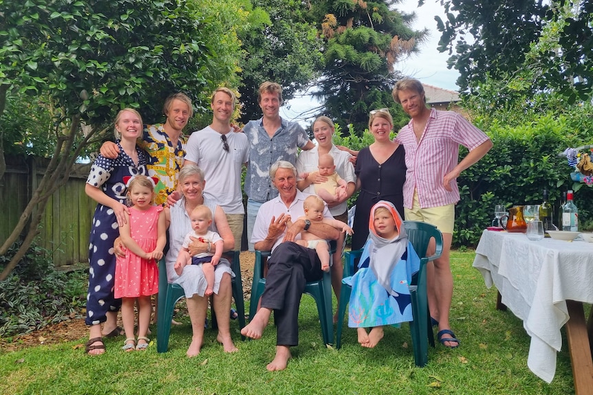 A family posing for a photo in a backyard