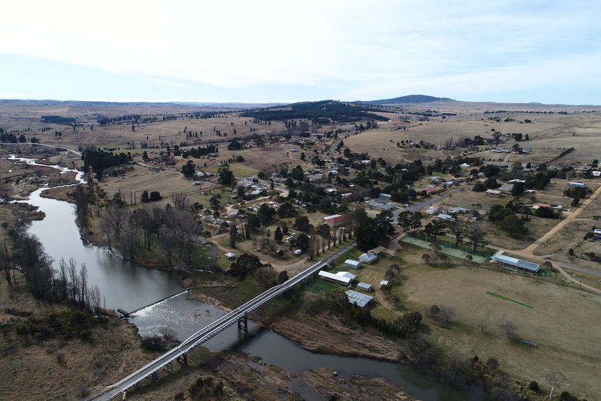 A drone photo of a small rural town by a river