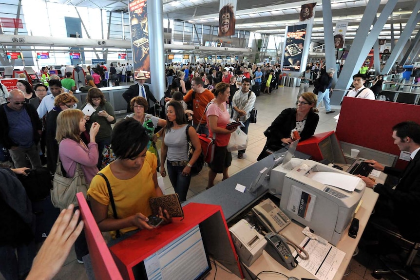 Qantas passengers make alternative arrangements at the Virgin service desks.