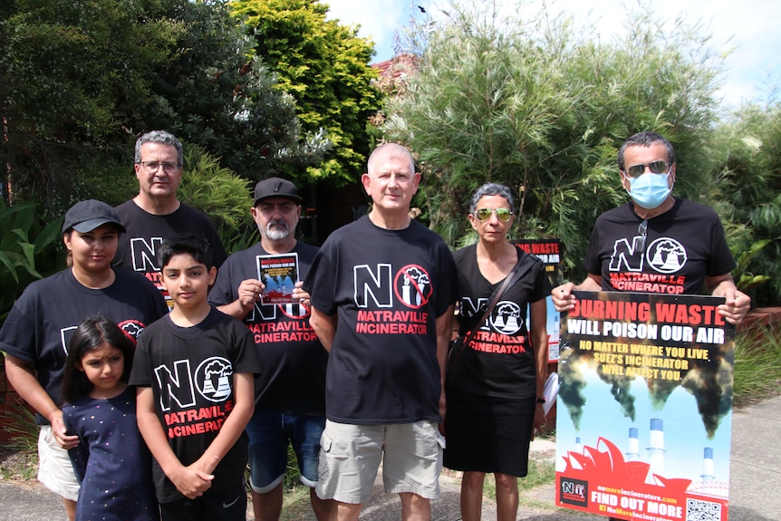 A group of adults and children wearing shirts that read 'no more incinerators'