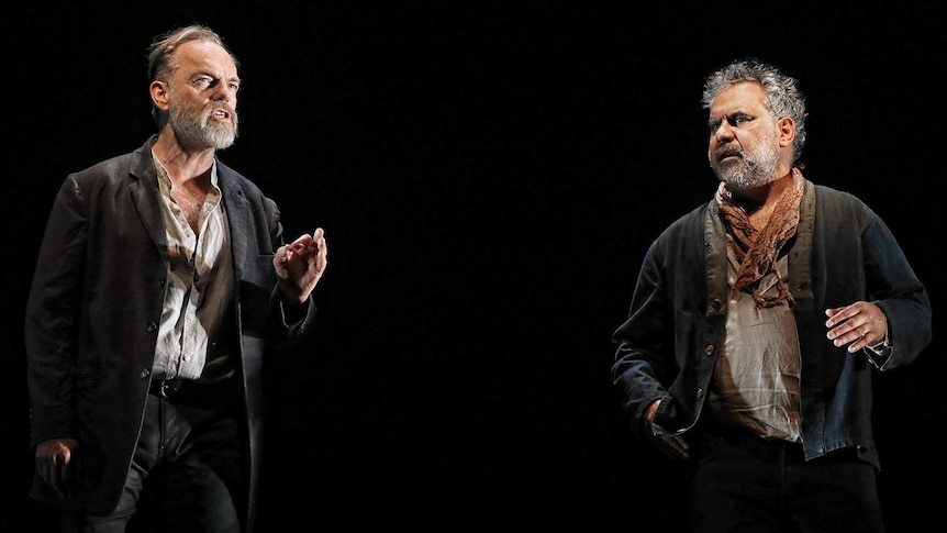 Darkened stage with Hugo Weaving and Wayne Blair standing on curved set.