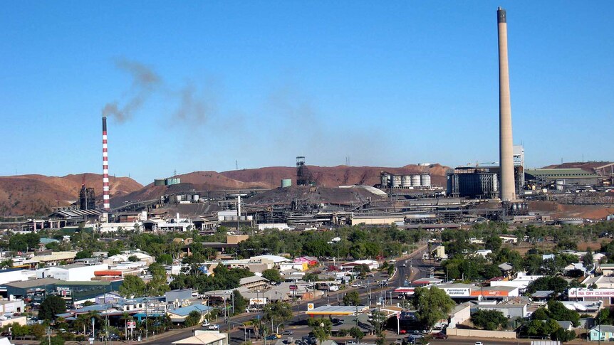 Smoke stacks overhang the streets of Mount Isa