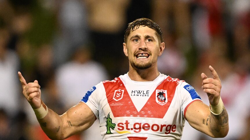 NRL player Zac Lomax of the Dragons celebrates by pointing his fingers at supporters