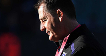 A profile shot of Ross Lyon looking down.