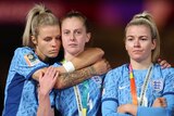 Rachel Daly, Keira Walsh and Lauren Hemp stand and look sad