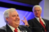 Clive Palmer smiles as Bob Katter speaks at the National Press Club