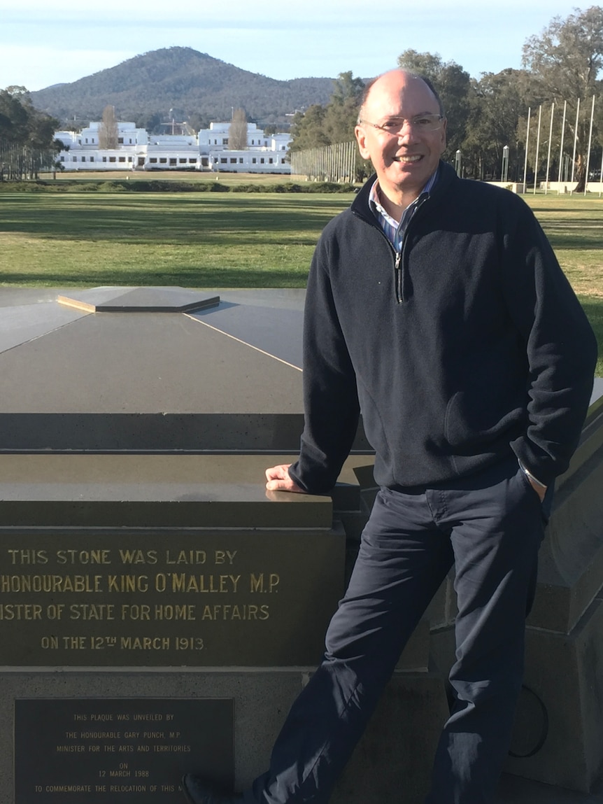 Robert Reid stands at the foundation stone in front of Old Parliament House.