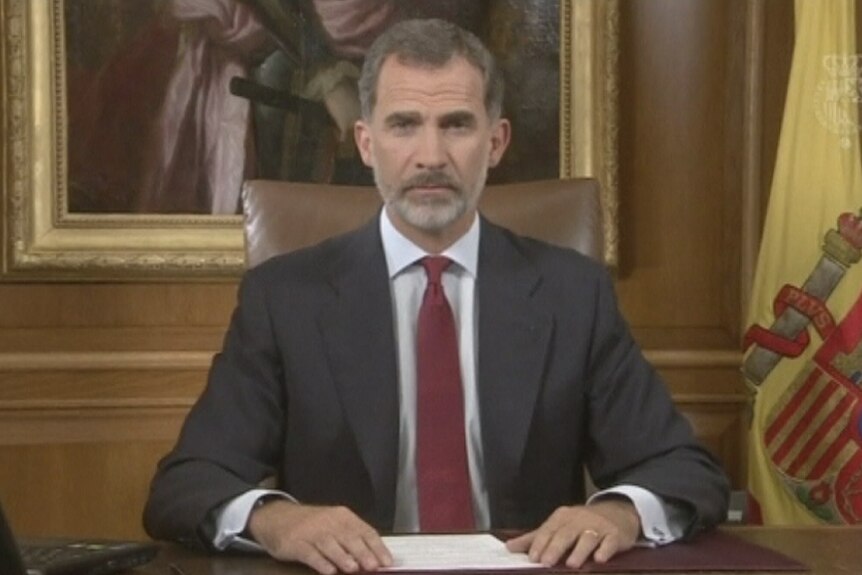 Spain's King Felipe looks at the camera as he delivers a speech in his office.