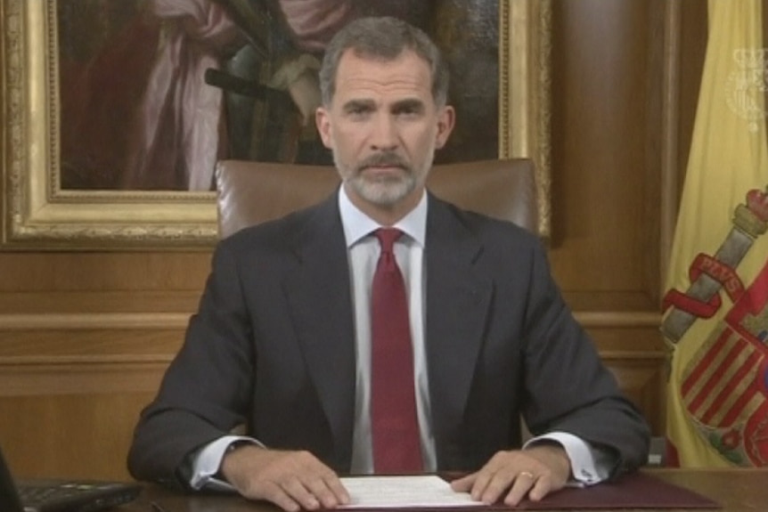 Spain's King Felipe looks at the camera as he delivers a speech in his office.
