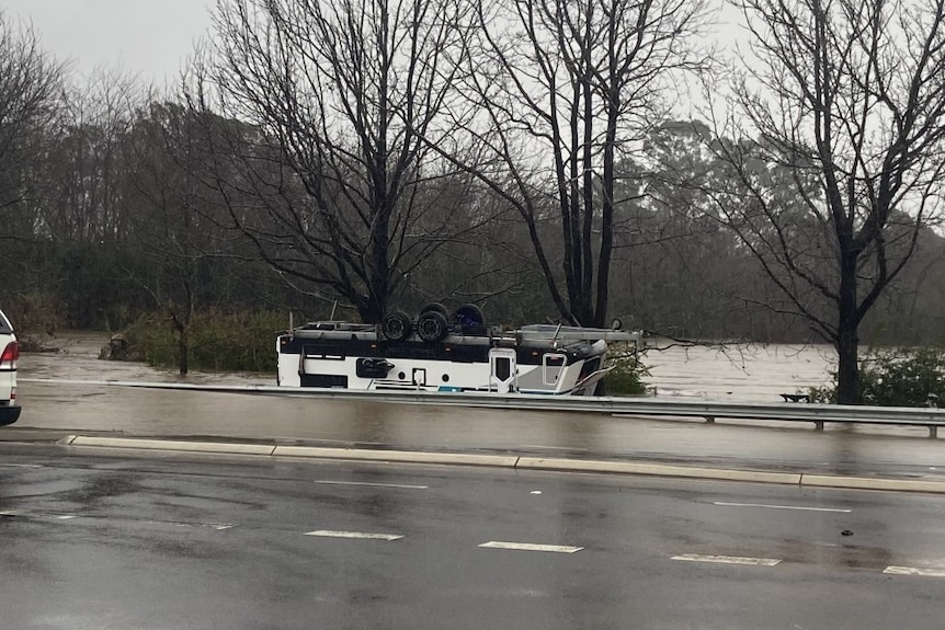  A caravan upside down on the side of the road