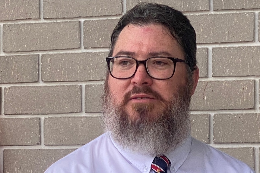  Outgoing Member for Dawson George Christensen in front of a brick wall