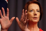 Julia Gillard has edged ahead of Tony Abbott as preferred prime minister but Labor's momentum has stalled.