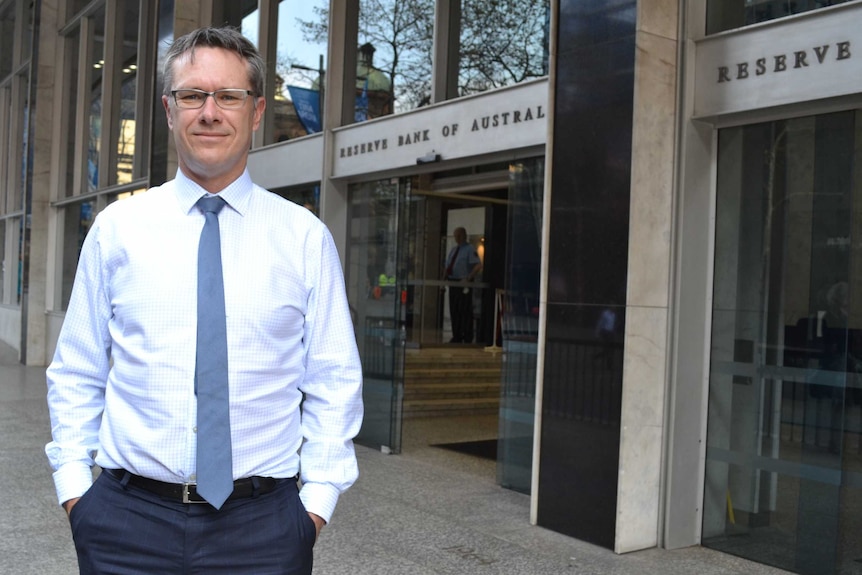 Guy Debelle stands outside the Reserve Bank head office
