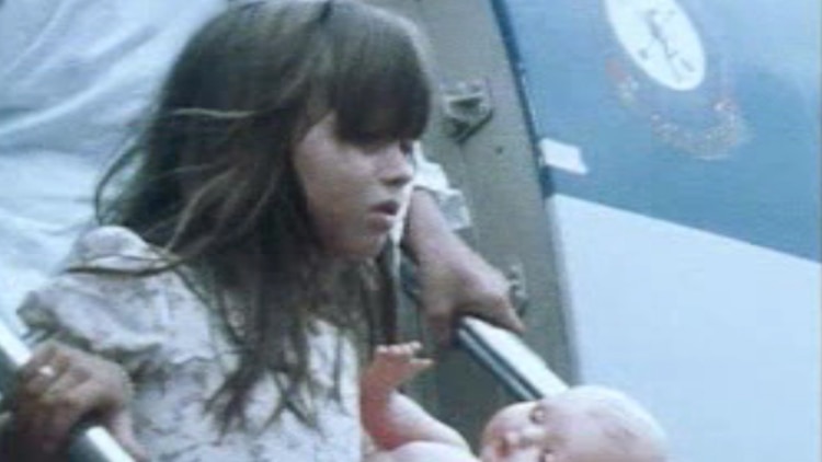 A young girl disembarks a plane after being evacuated from Cyclone Tracy devastated Darwin.