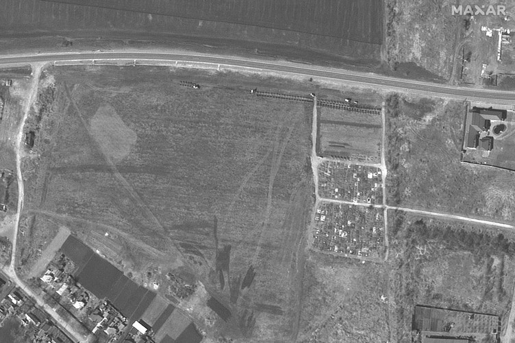 Half a row of graves have been dug quite a distance from an existing cemetery.