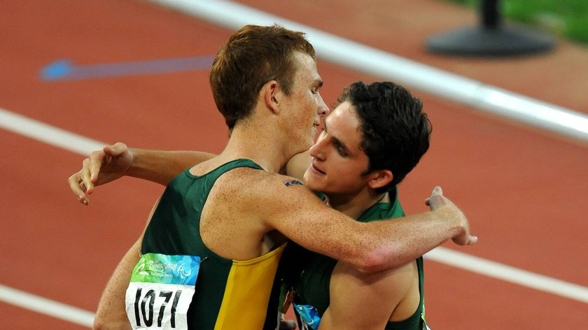 Australia's Brad Scott congratulates South Africa's Fanie van der Merwe after the men's 200m T37 final.